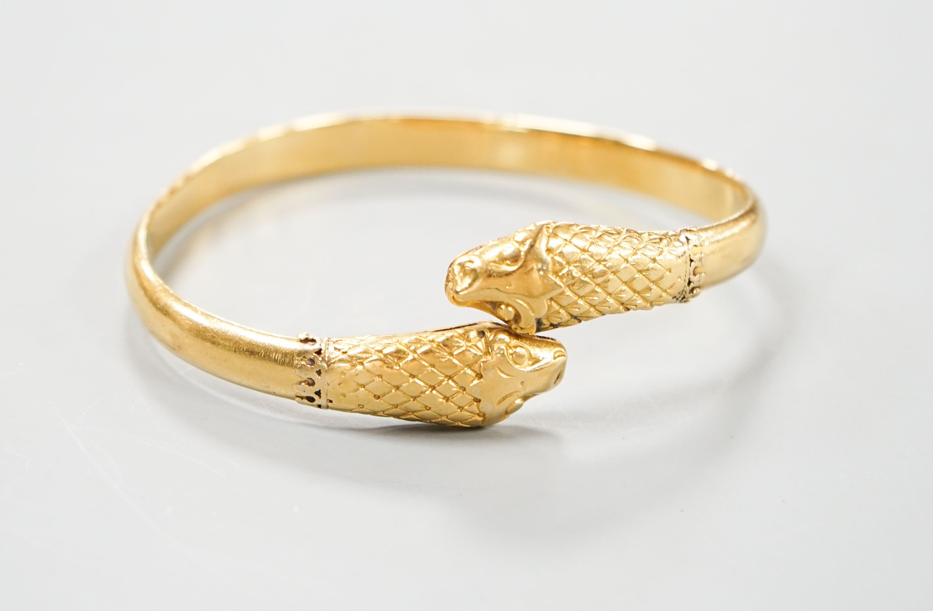 An Indian yellow metal twin headed serpent bangle